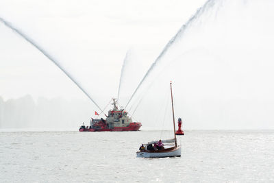 Fire boat with fountains of water in the air