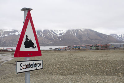 Information sign on landscape against sky