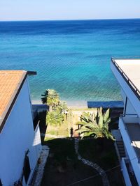 Swimming pool by sea against clear sky