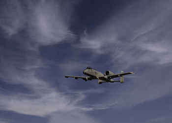 Low angle view of airplane flying in sky