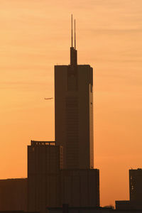 Silhouette of building against sky during sunset