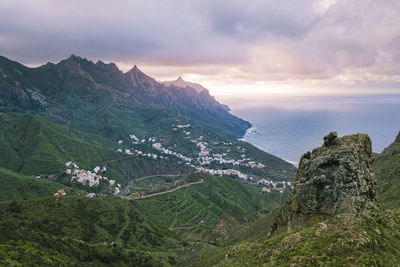 Scenic view of sea and mountains against sky