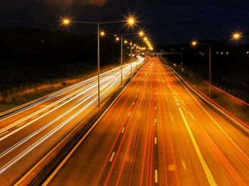 High angle view of light trails on road at night