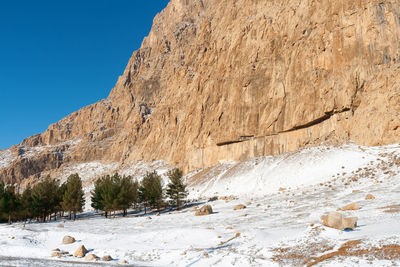 Scenic view of snow covered unfinished sasanian relief a part of behistan site. 
