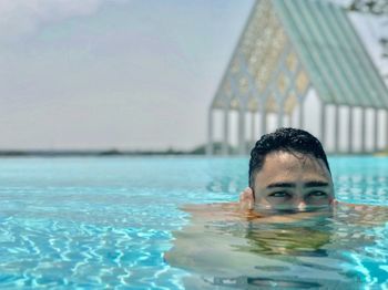 Portrait of man swimming in pool