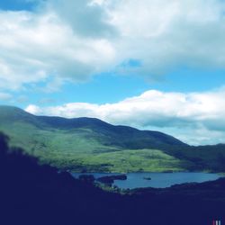 Scenic view of mountains against cloudy sky