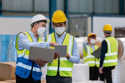 Engineers brainstorming in factory