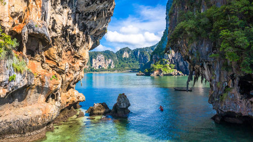 Scenic view of rocks in sea against sky