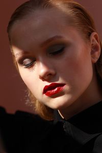 Close-up of young woman wearing make-up with eyes closed