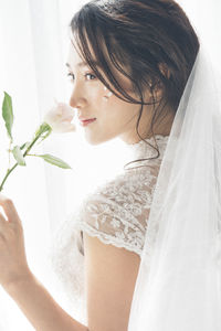 Portrait of woman holding white flowers