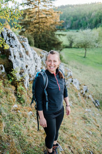 Portrait of a smiling young woman on rock