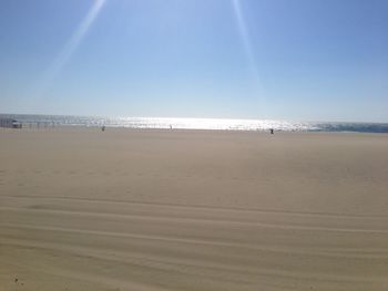 Scenic view of beach against clear sky