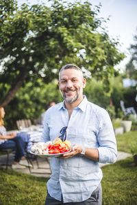 Portrait of a smiling young man eating food