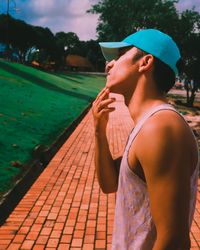 Side view of mid adult man standing at park