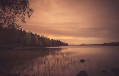 Scenic view of lake against sky during sunset