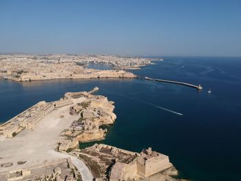 High angle view of sea and city against sky