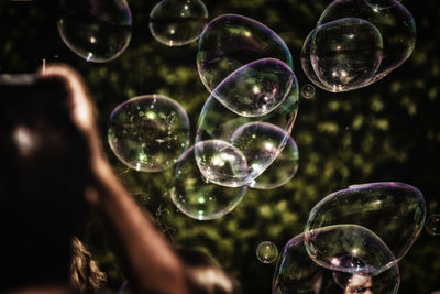 Close-up of person amidst bubbles