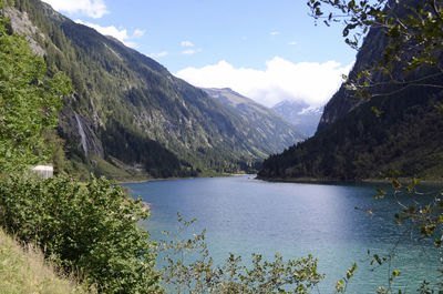 Scenic view of lake and mountains against sky