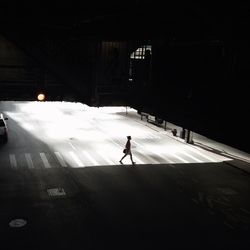 Woman walking on zebra crossing