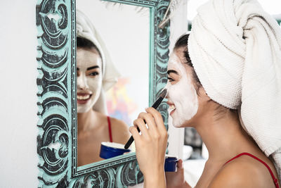 Close-up of woman by mirror