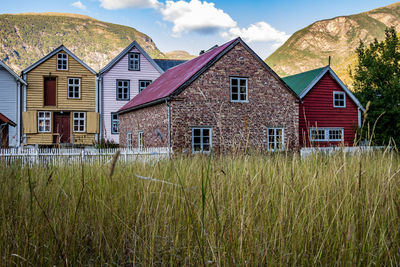 Houses on field against sky