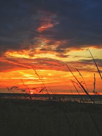 Scenic view of dramatic sky over sea during sunset