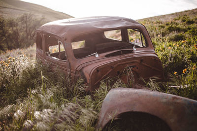 Abandoned car on field