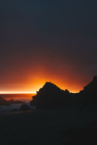 Scenic view of silhouette mountains against sky during sunset