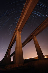Low angle view of bridge against sky at night
