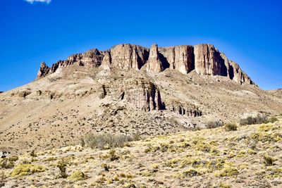 Scenic view of rocky mountains against clear blue sky