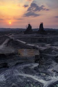 Rock formations at seaside during sunset