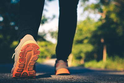 Low section of person standing on road