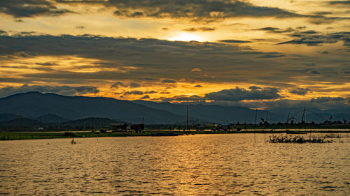 Scenic view of lake against sky during sunset