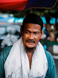 Man with scarf looking away