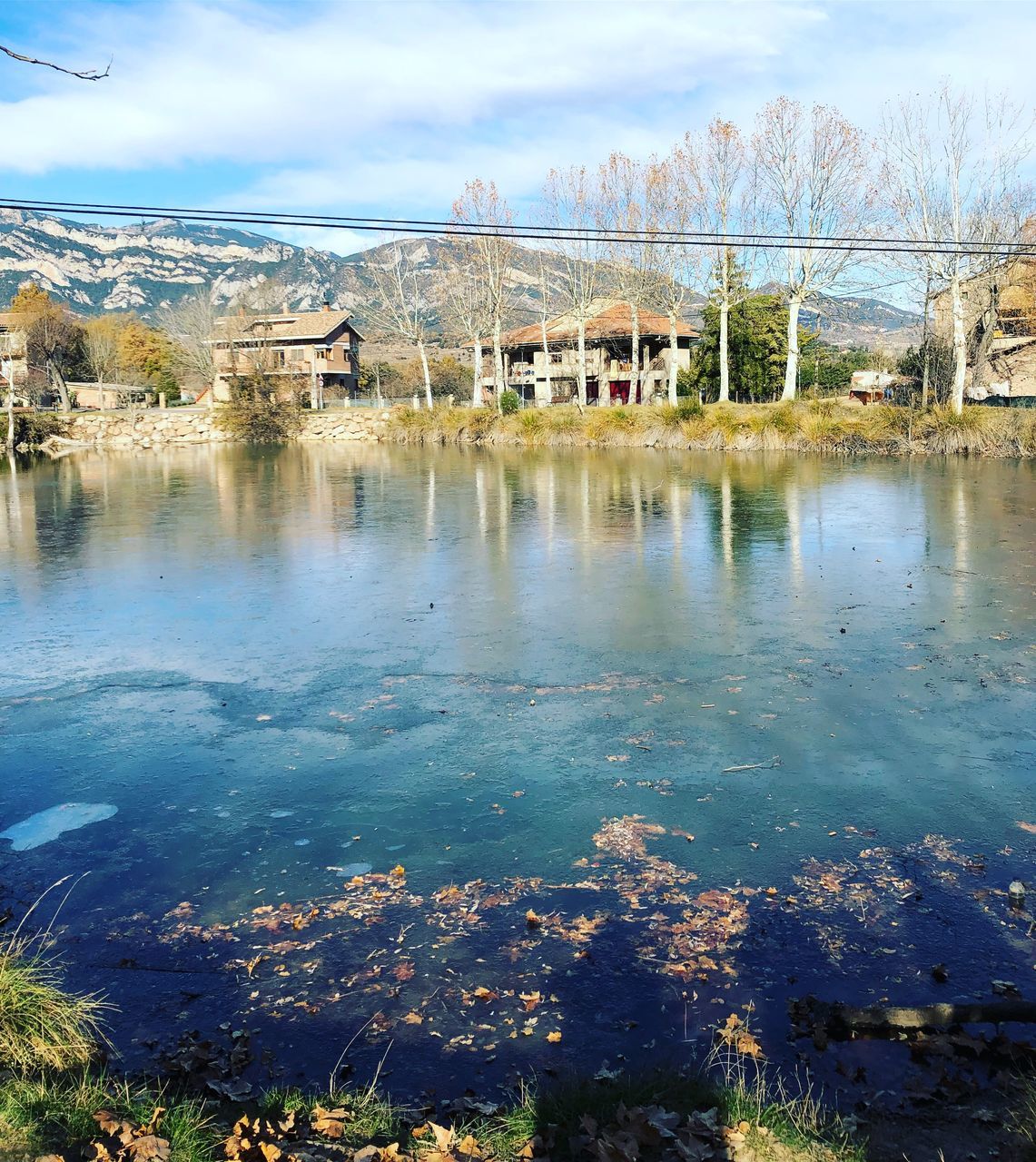 SCENIC VIEW OF LAKE AND BUILDINGS IN TOWN