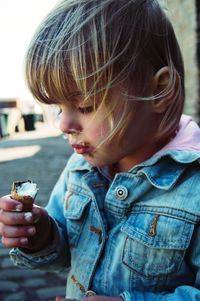 Close-up of girl having ice cream outdoors