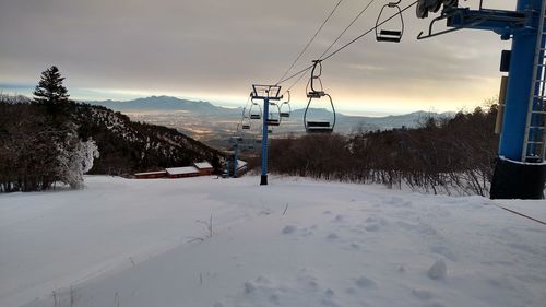 Ski lift over snow covered mountains