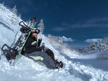 Person skiing on snowcapped mountain against sky