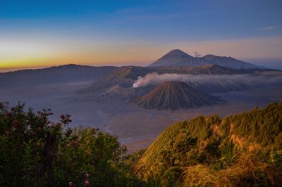 View of volcanic landscape against sky during sunset