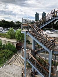 Bridge by buildings against sky