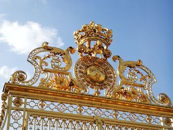 Low angle view of ornate building against blue sky