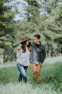 Young couple close in embrace on field