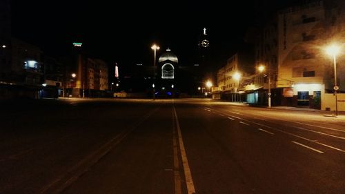 Illuminated road in city at night