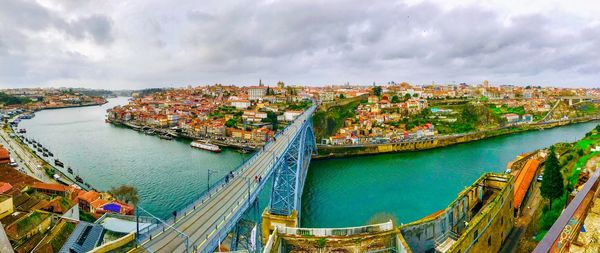 High angle view of cityscape by sea against sky