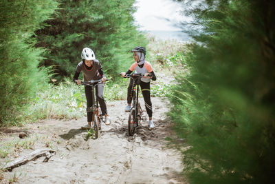 Rear view of man riding bicycle