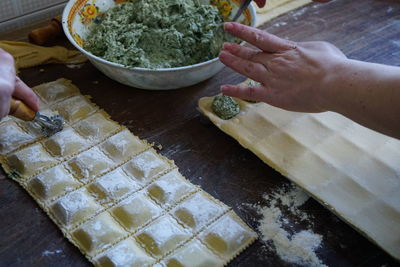 Midsection of person preparing food at table