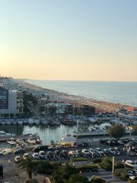 High angle view of buildings by sea against clear sky