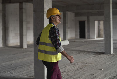 Senior architect walking at site