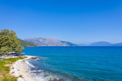 Scenic view of sea against clear blue sky