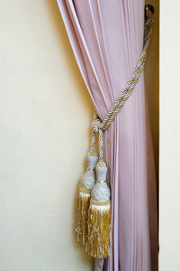 Close-up of decoration hanging against white wall